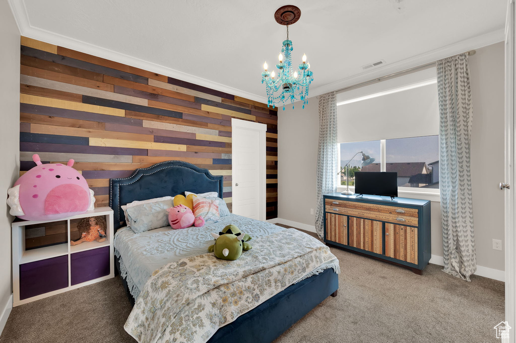 Bedroom with a chandelier and carpet floors