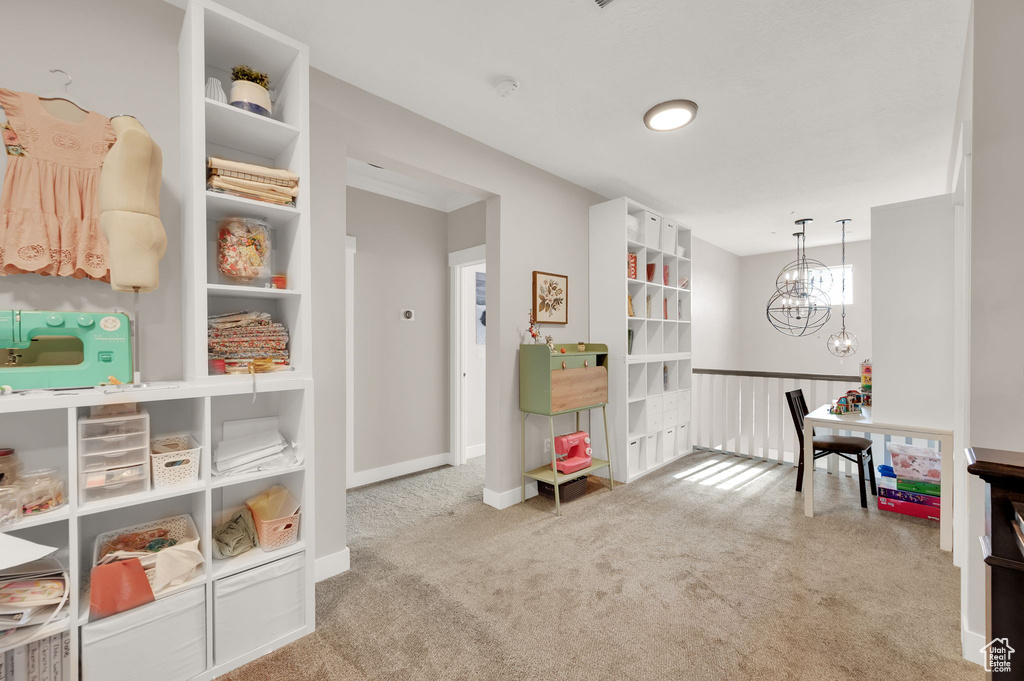 Playroom featuring carpet and a chandelier