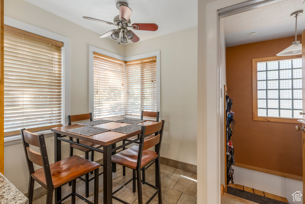 Dining room with a ceiling fan and light tile patterned floors