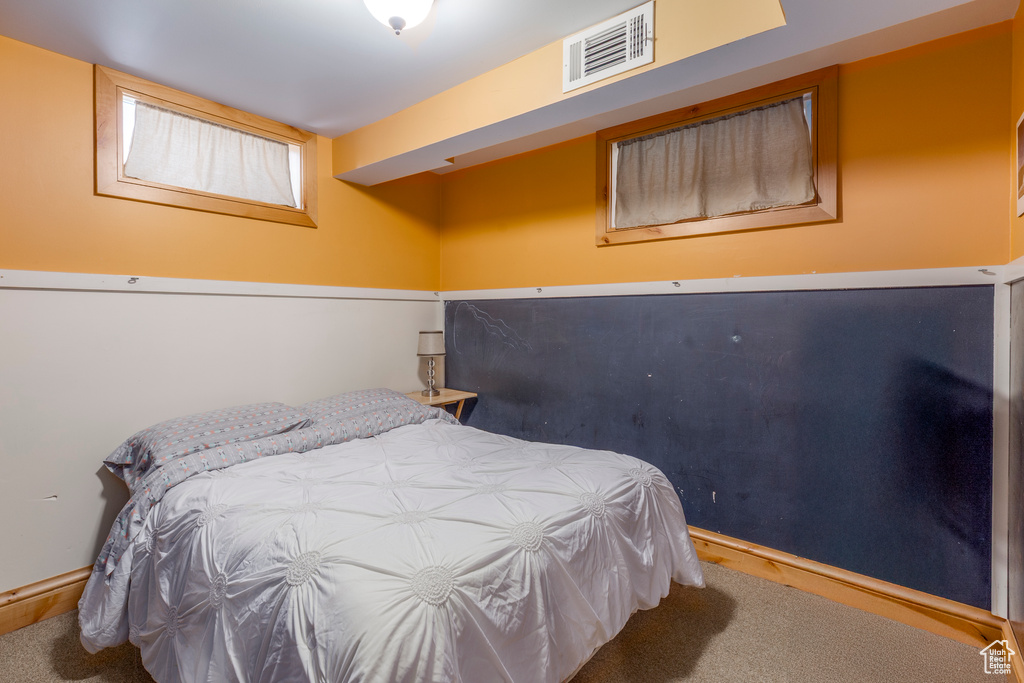 Bedroom featuring carpet and baseboards