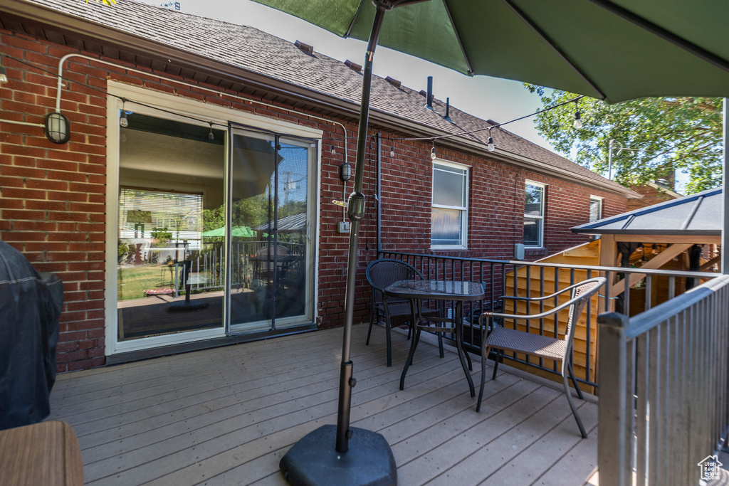 Wooden terrace with a grill and outdoor dining area