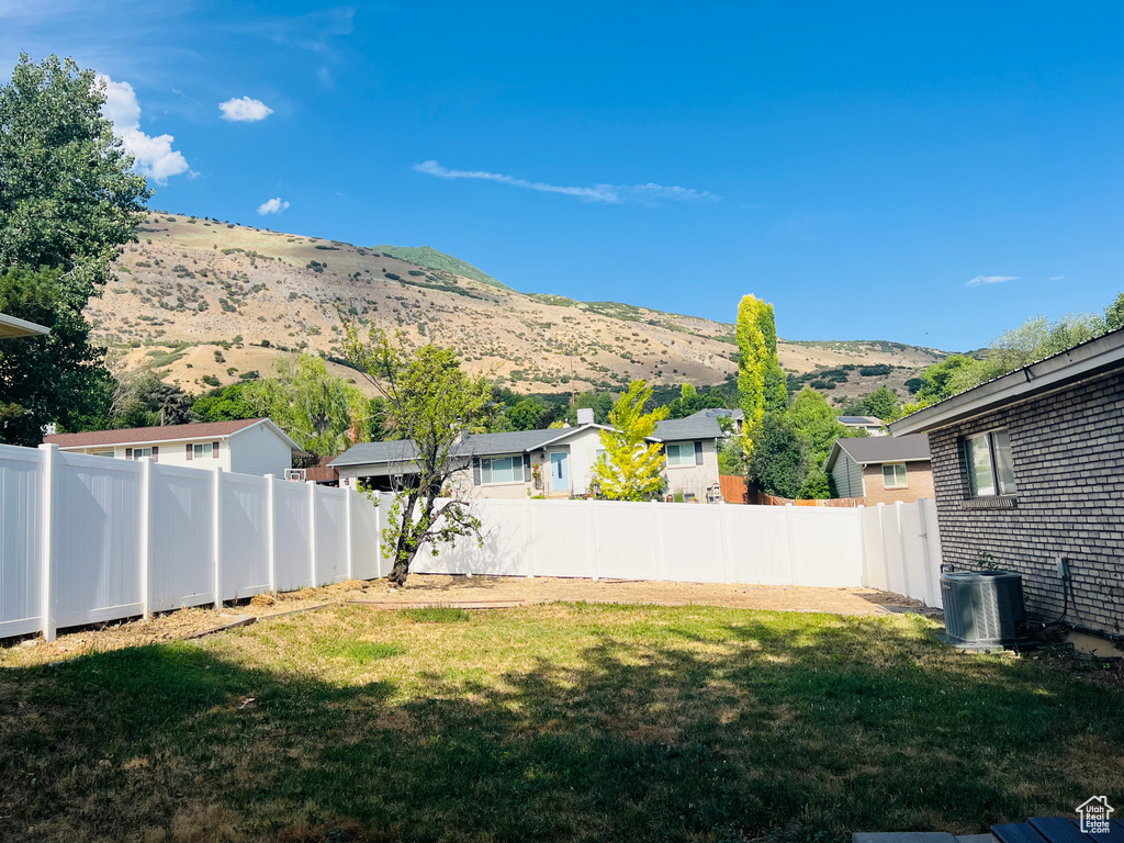 Fenced backyard featuring a mountain view and a residential view