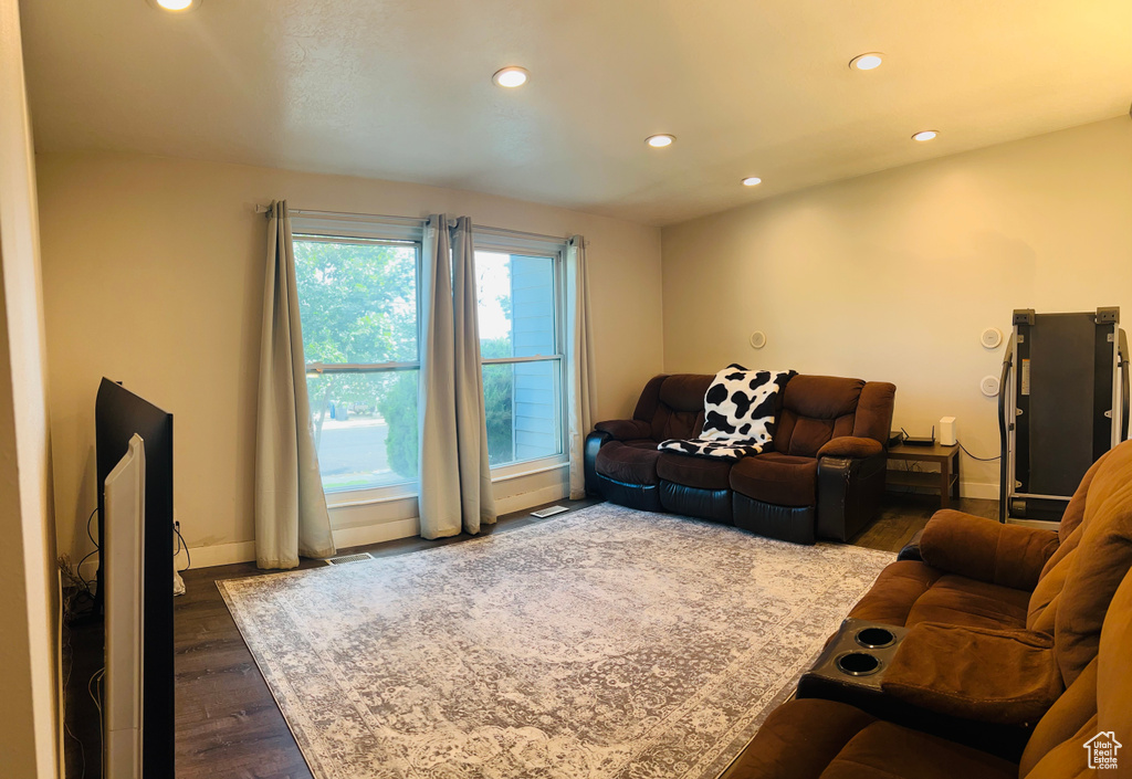 Living area featuring recessed lighting and dark wood finished floors