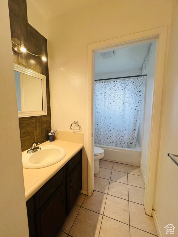 Full bathroom with vanity, tile patterned floors, and shower / bath combo