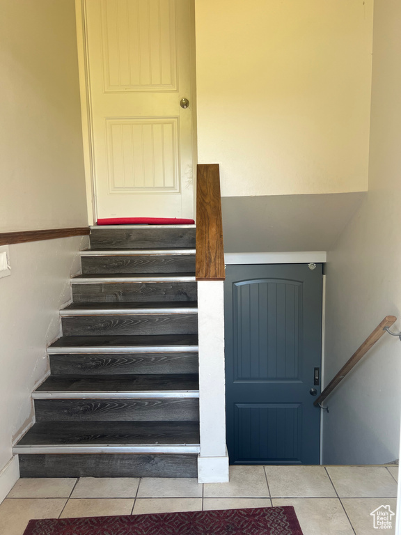 Staircase featuring tile patterned floors