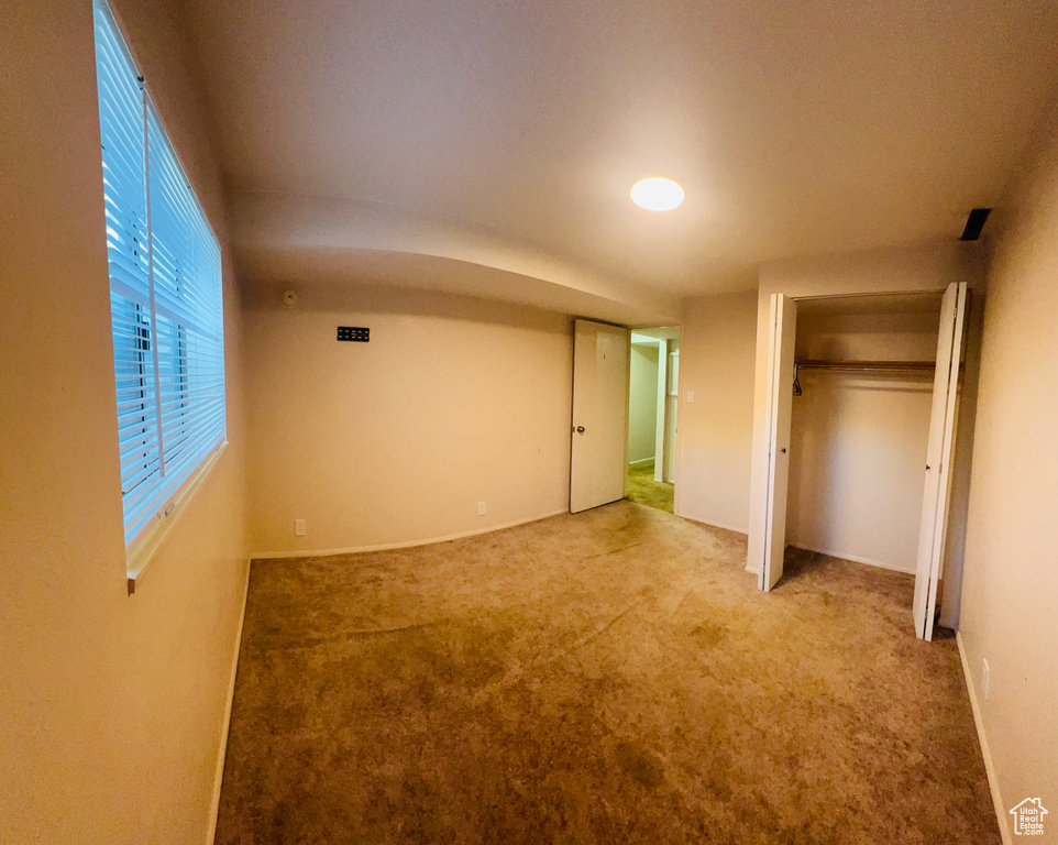 Unfurnished bedroom with carpet flooring