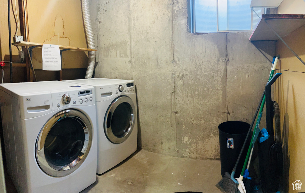 Washroom featuring washing machine and dryer