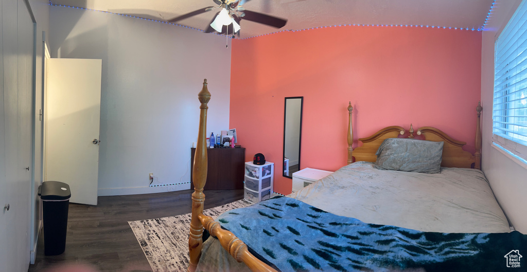 Bedroom featuring wood finished floors and baseboards
