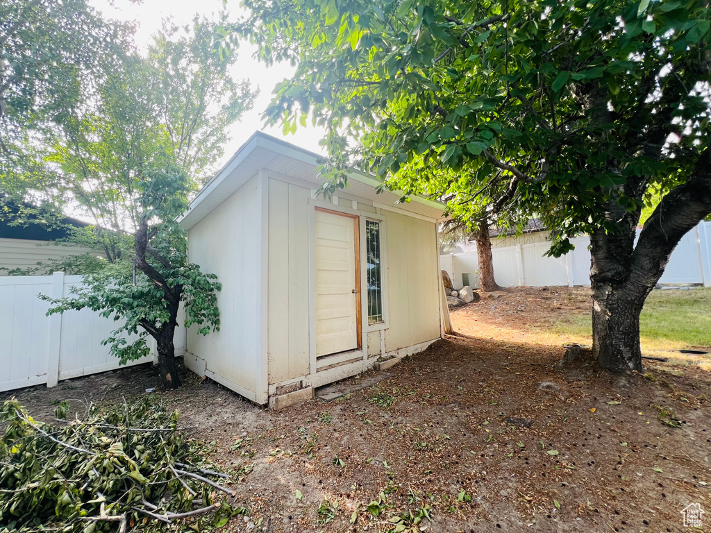 View of shed with a fenced backyard