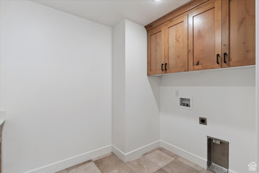 Washroom featuring cabinet space, electric dryer hookup, and hookup for a washing machine