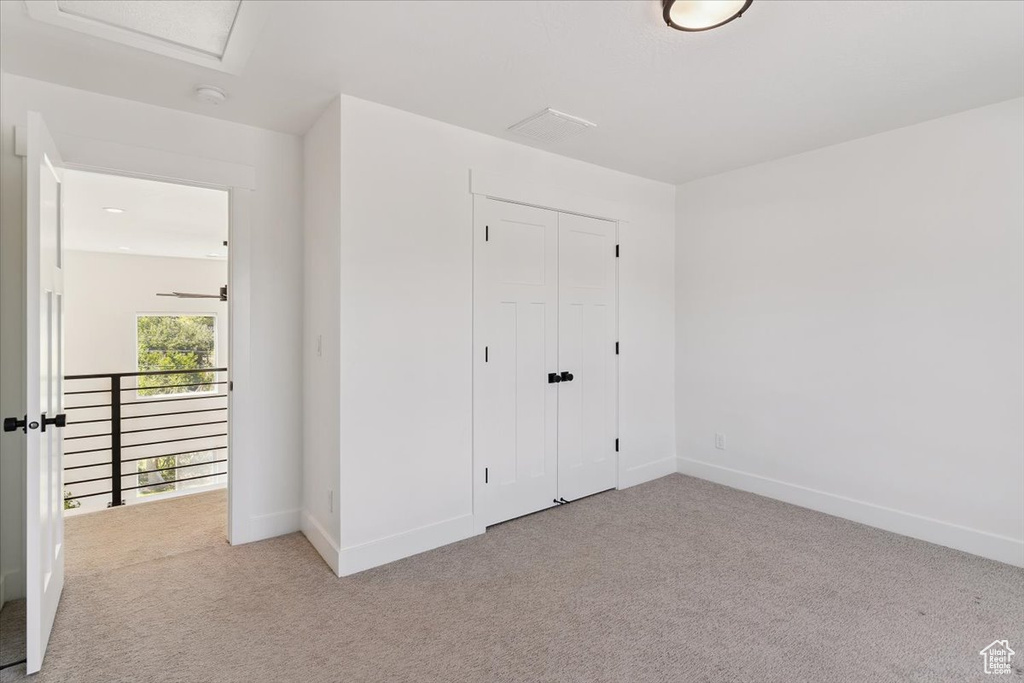 Unfurnished bedroom with carpet and a closet