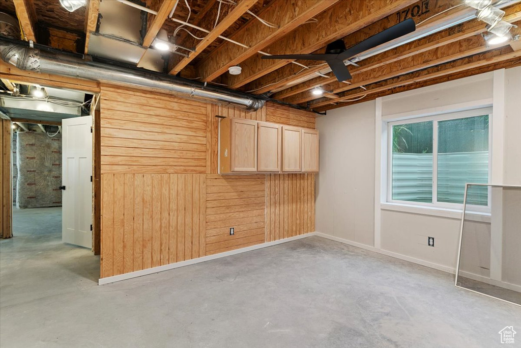 Basement featuring wooden walls