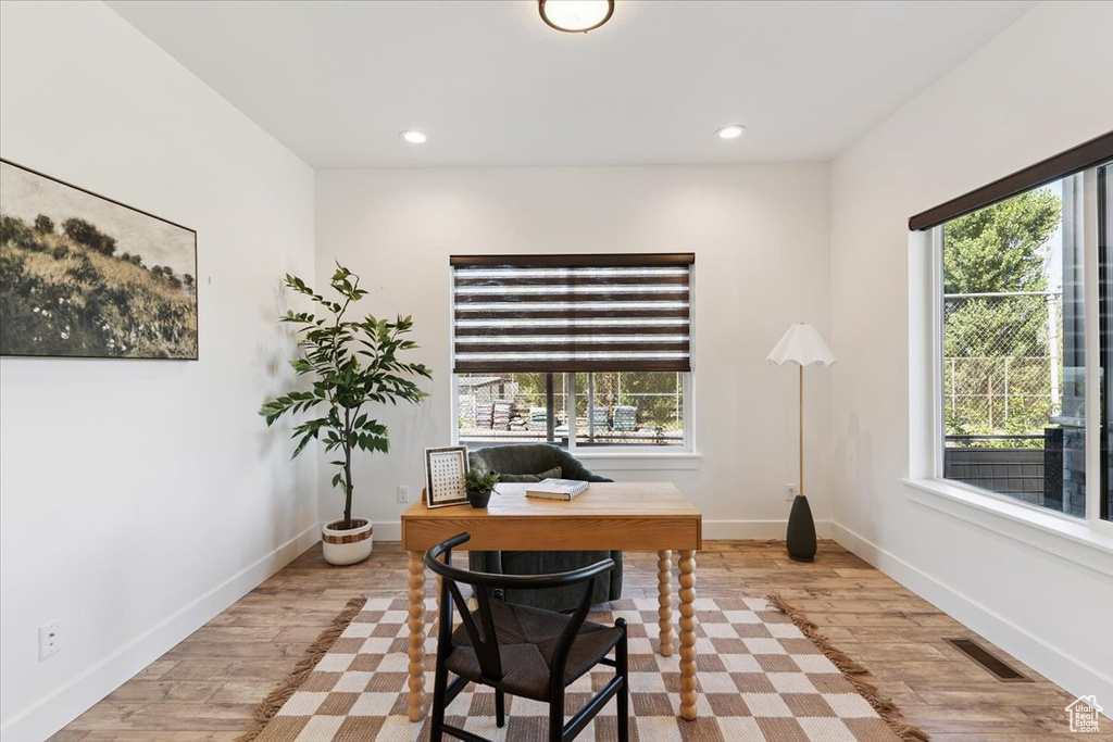 Home office featuring wood finished floors and recessed lighting