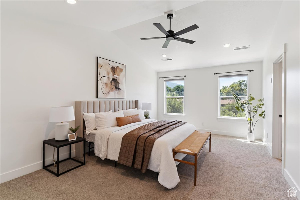 Carpeted bedroom featuring vaulted ceiling, recessed lighting, and a ceiling fan