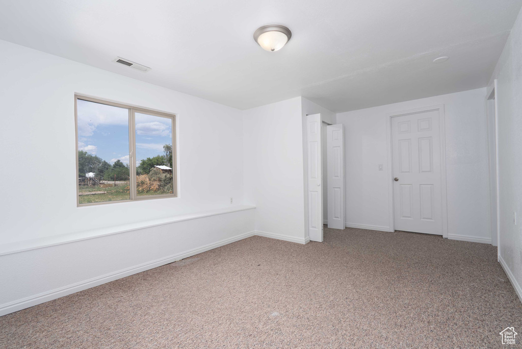 Unfurnished bedroom featuring carpet and baseboards