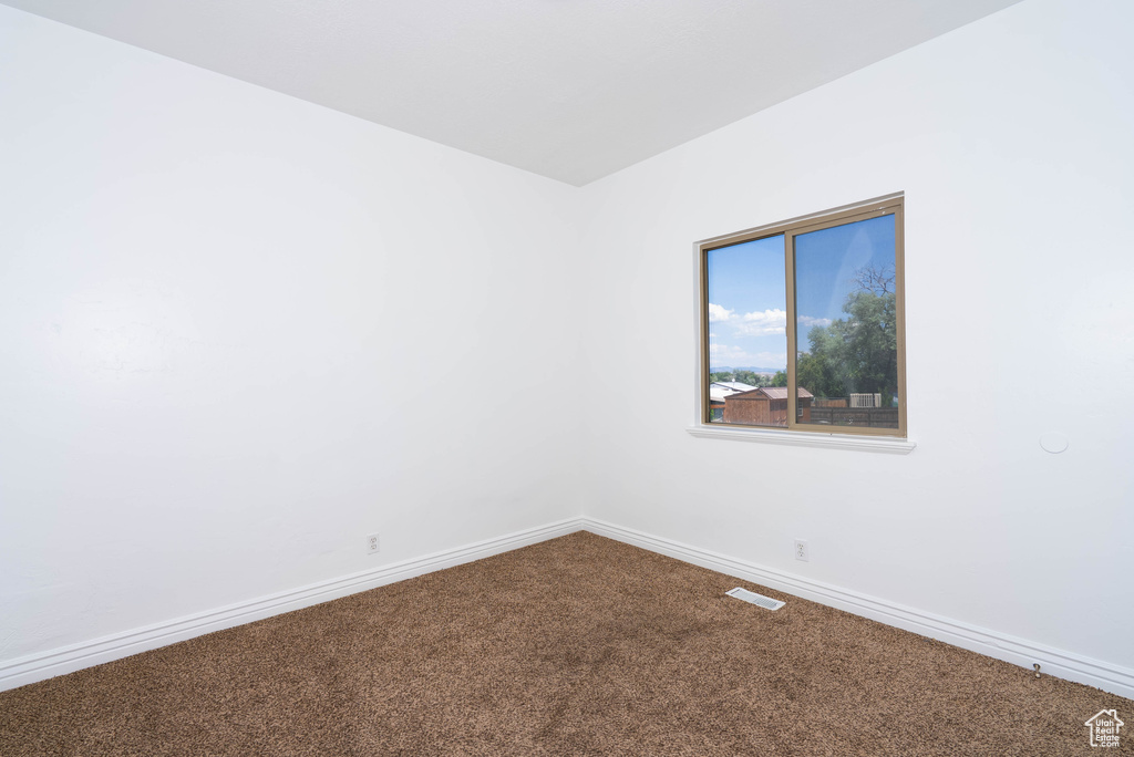 Unfurnished room with carpet and baseboards