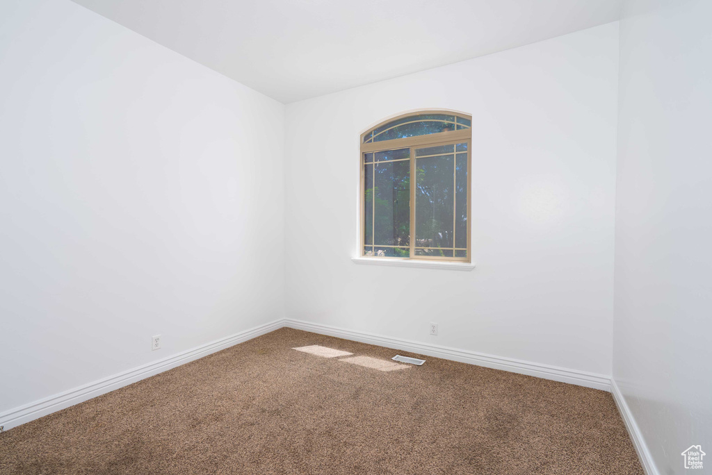 Unfurnished room featuring carpet flooring
