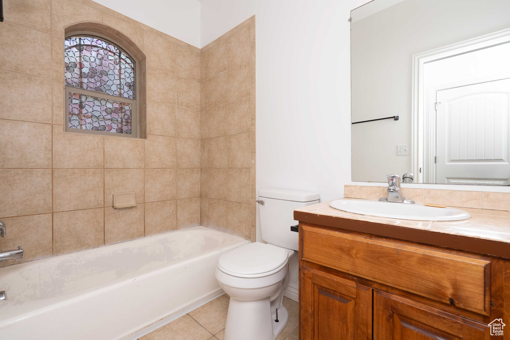 Bathroom with vanity, tile patterned flooring, and shower / tub combination