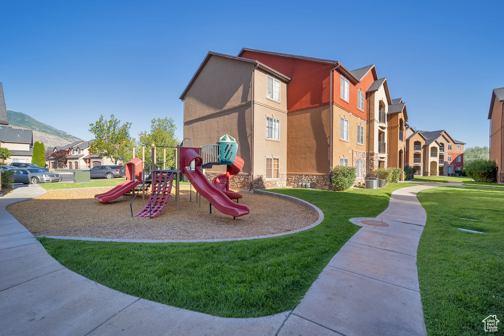 Community jungle gym featuring a lawn and a residential view