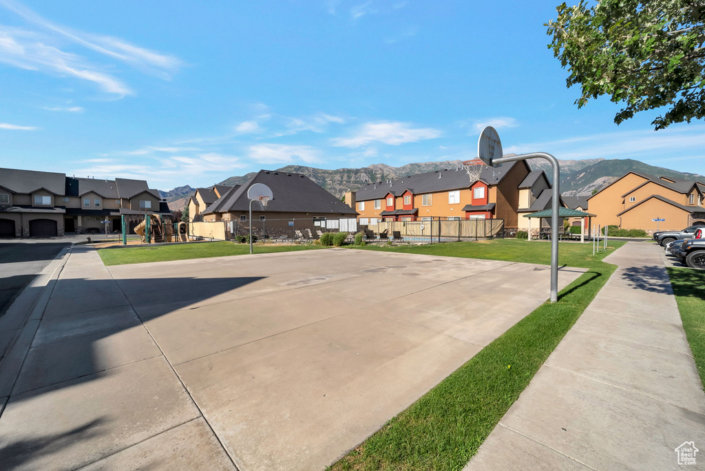 Surrounding community featuring a residential view, community basketball court, and a mountain view
