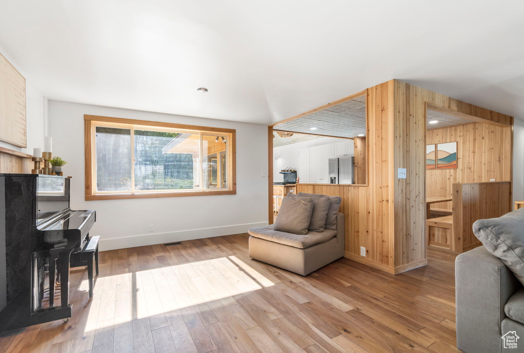 Living room with wooden walls and wood finished floors