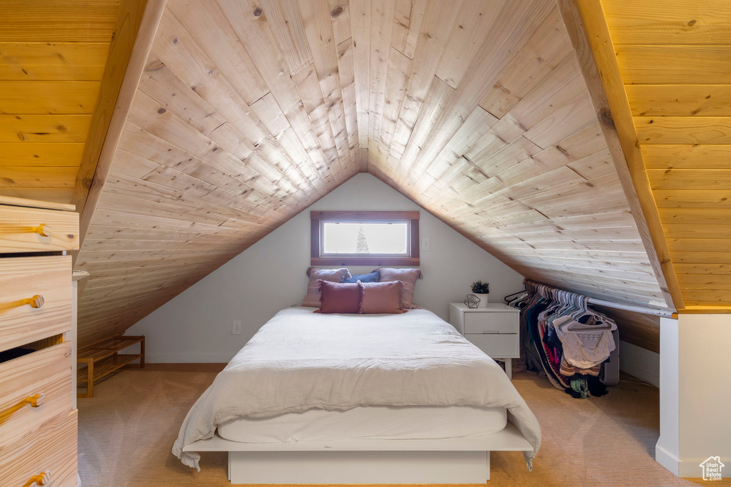 Carpeted bedroom with wood ceiling and lofted ceiling
