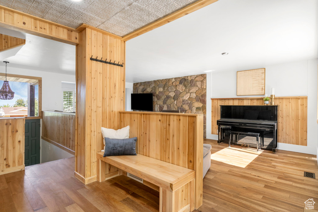 Sitting room featuring hardwood / wood-style floors and wood walls
