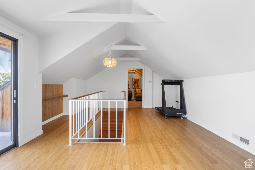 Bonus room featuring wood finished floors and lofted ceiling