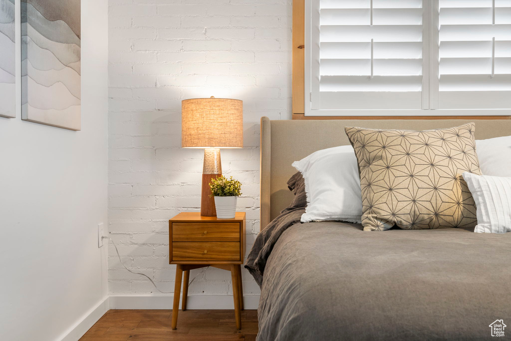 Bedroom with baseboards and wood finished floors