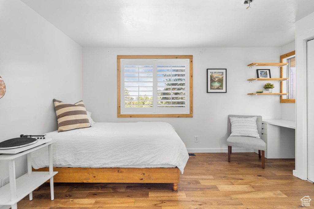 Bedroom featuring light wood finished floors and baseboards