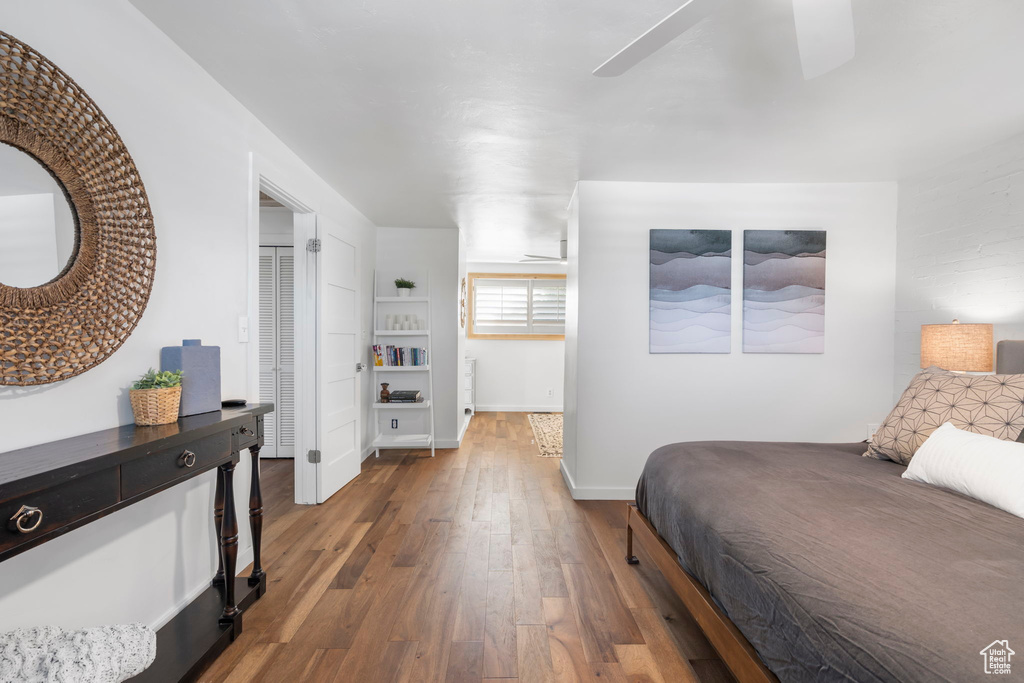 Bedroom with wood finished floors and baseboards