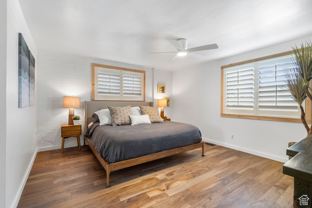 Bedroom with wood finished floors and ceiling fan
