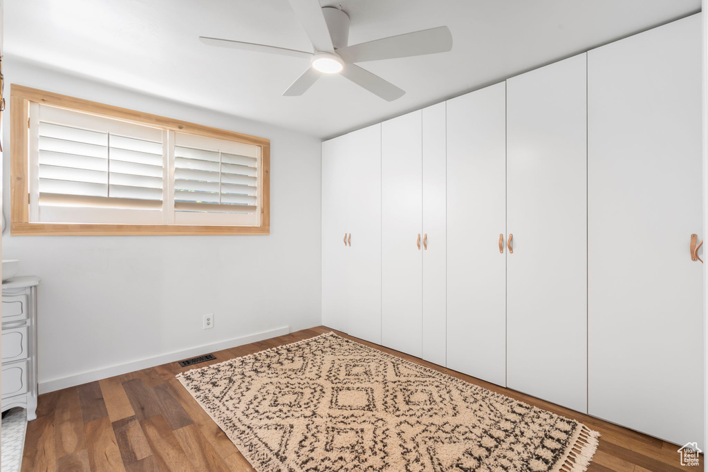 Unfurnished bedroom featuring wood finished floors and a ceiling fan