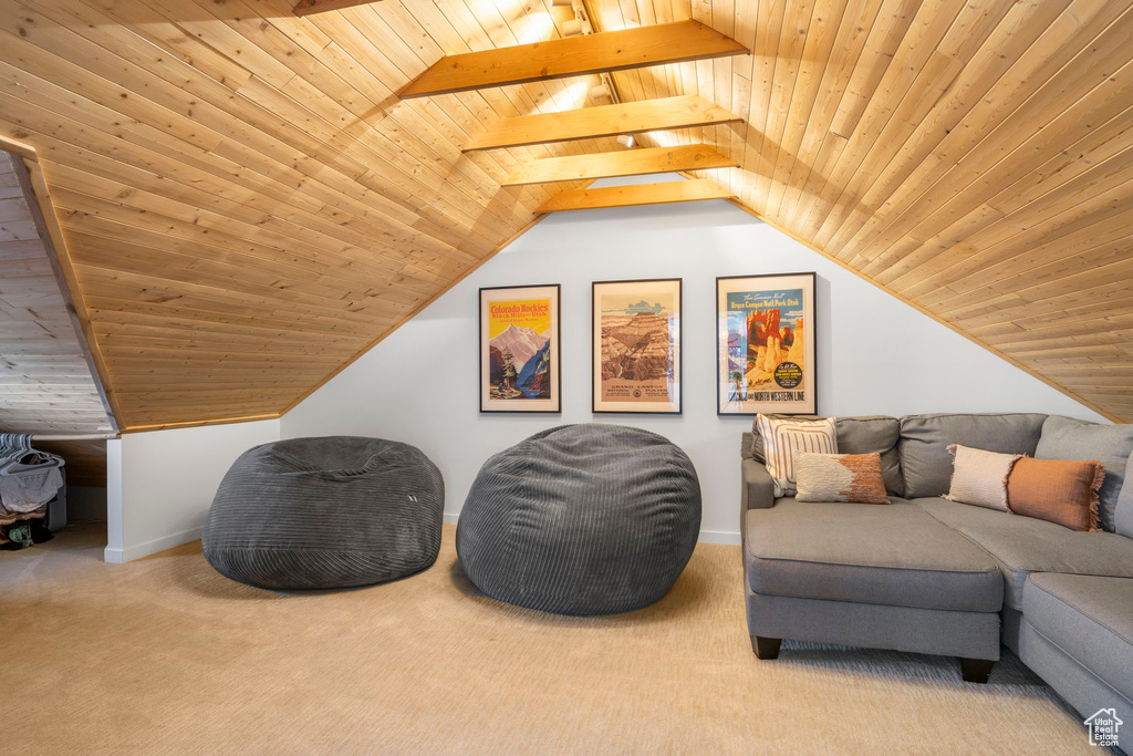 Sitting room featuring wooden ceiling, carpet flooring, and lofted ceiling