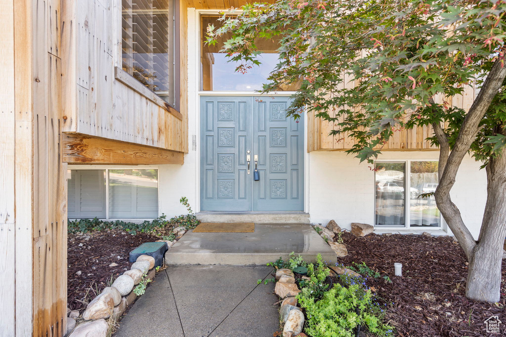 Entrance to property with stucco siding