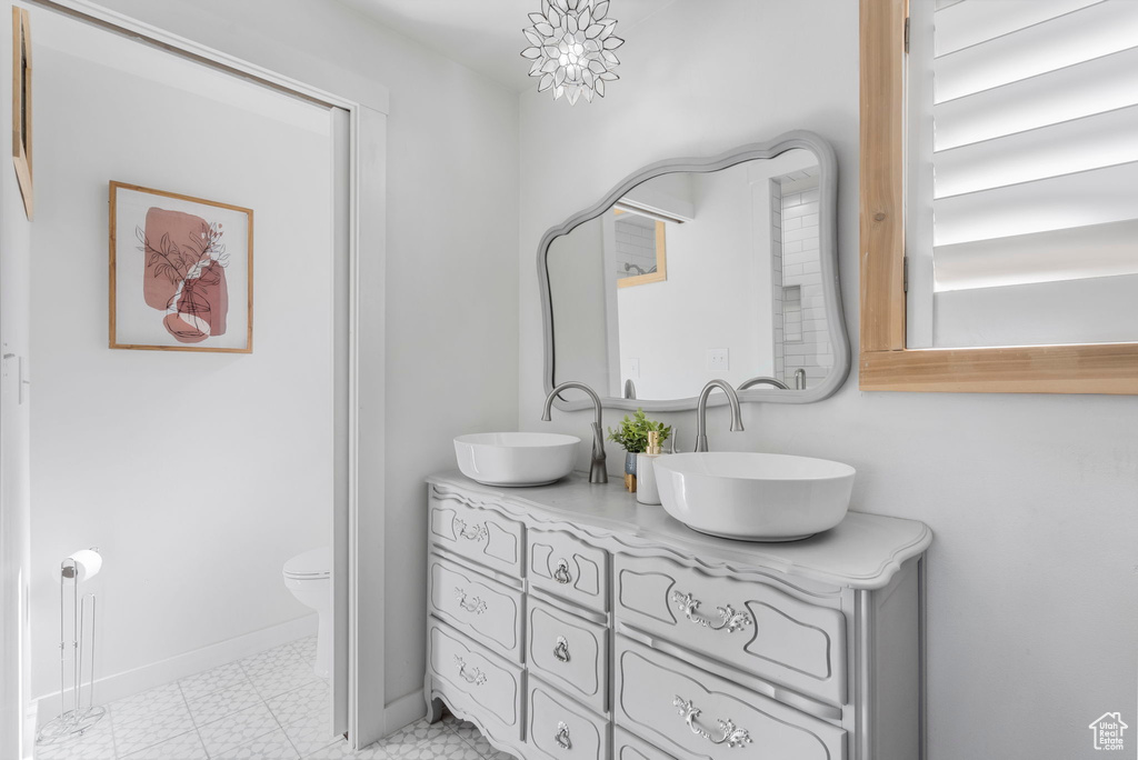 Full bath featuring double vanity and tile patterned floors