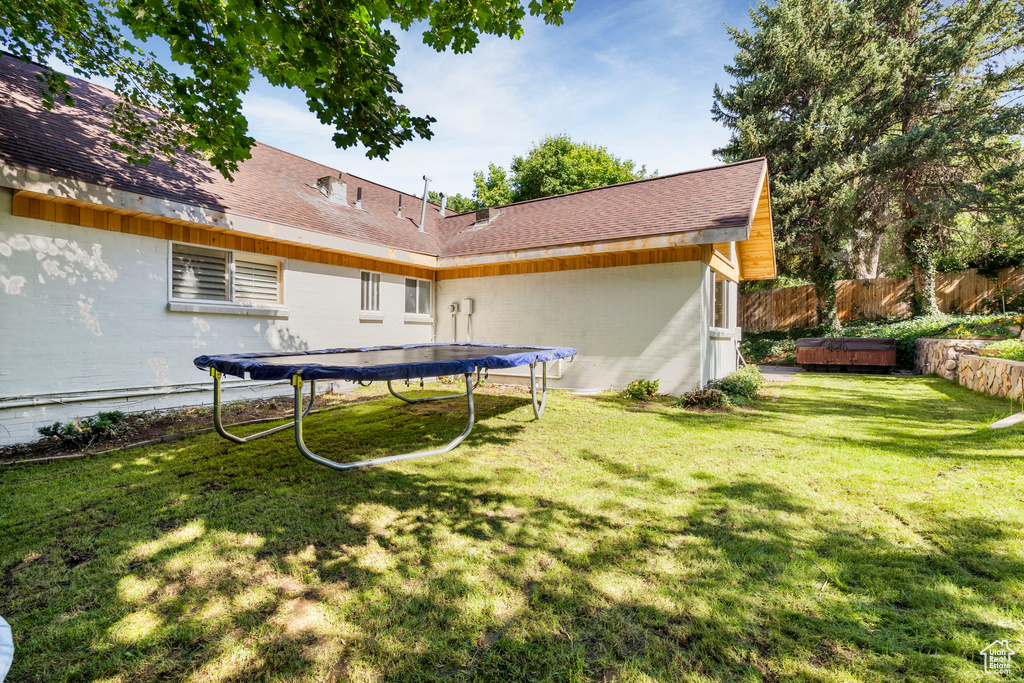 View of yard featuring a trampoline