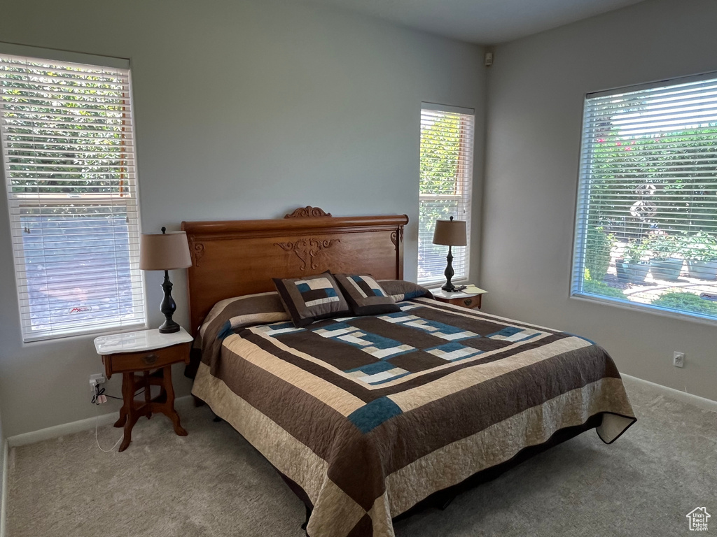 Bedroom featuring carpet flooring and baseboards