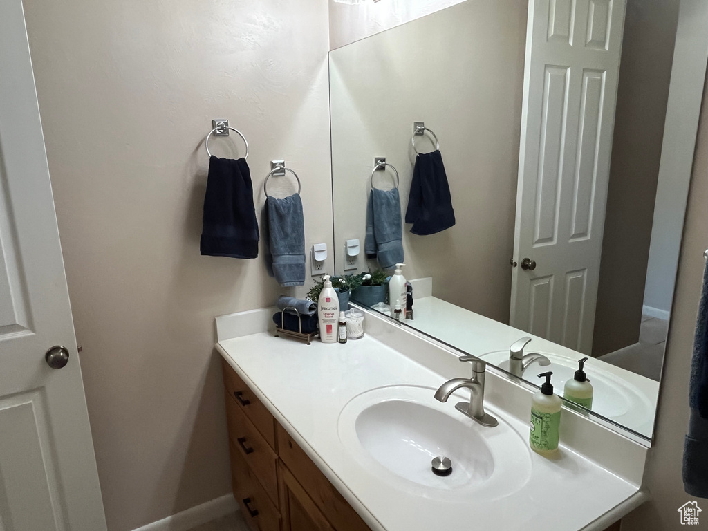 Bathroom featuring vanity and baseboards