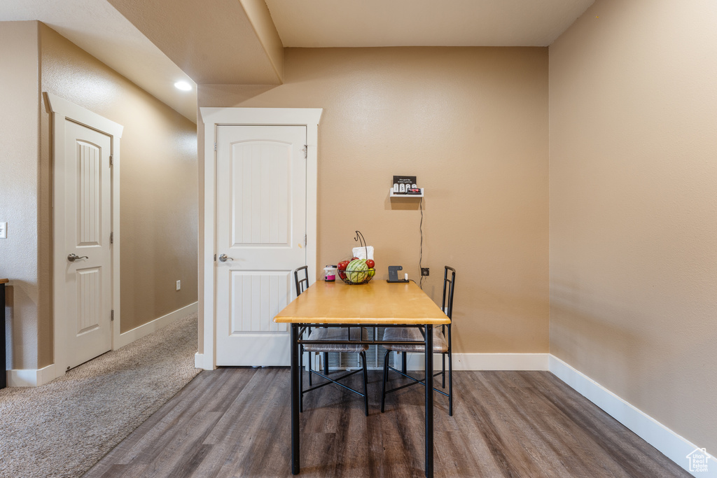 Dining space with wood finished floors and recessed lighting