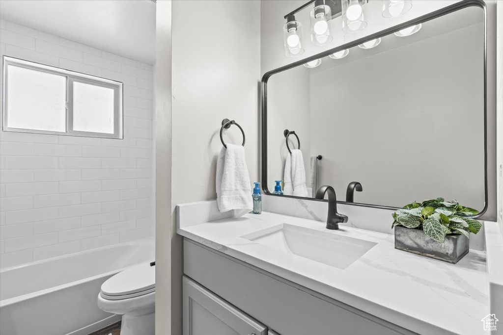 Bathroom with vanity and bathtub / shower combination