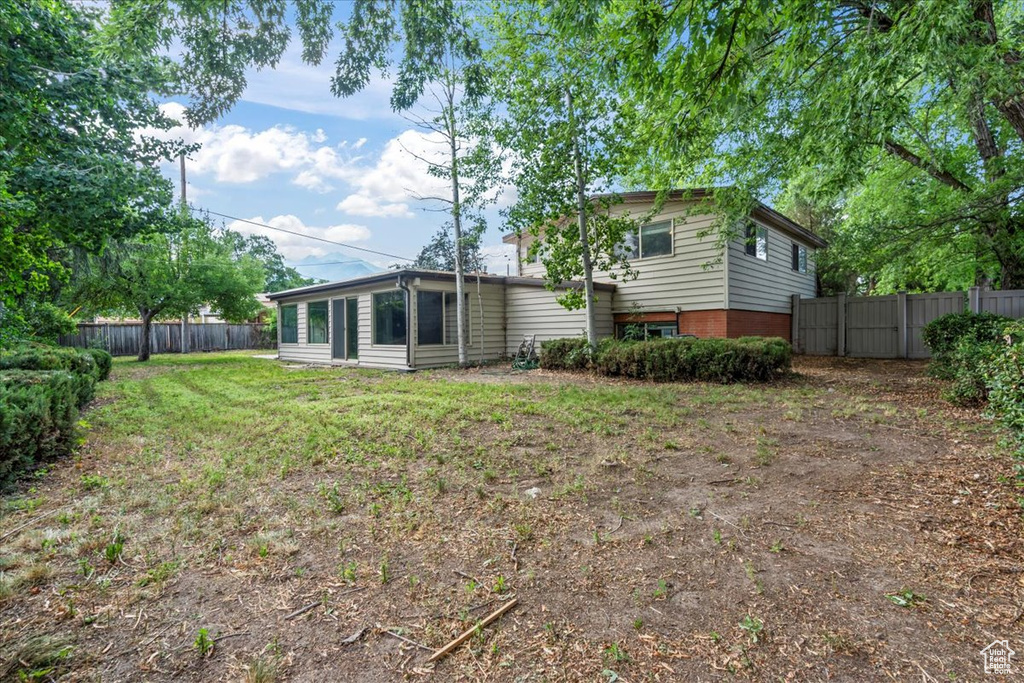 Rear view of property featuring brick siding