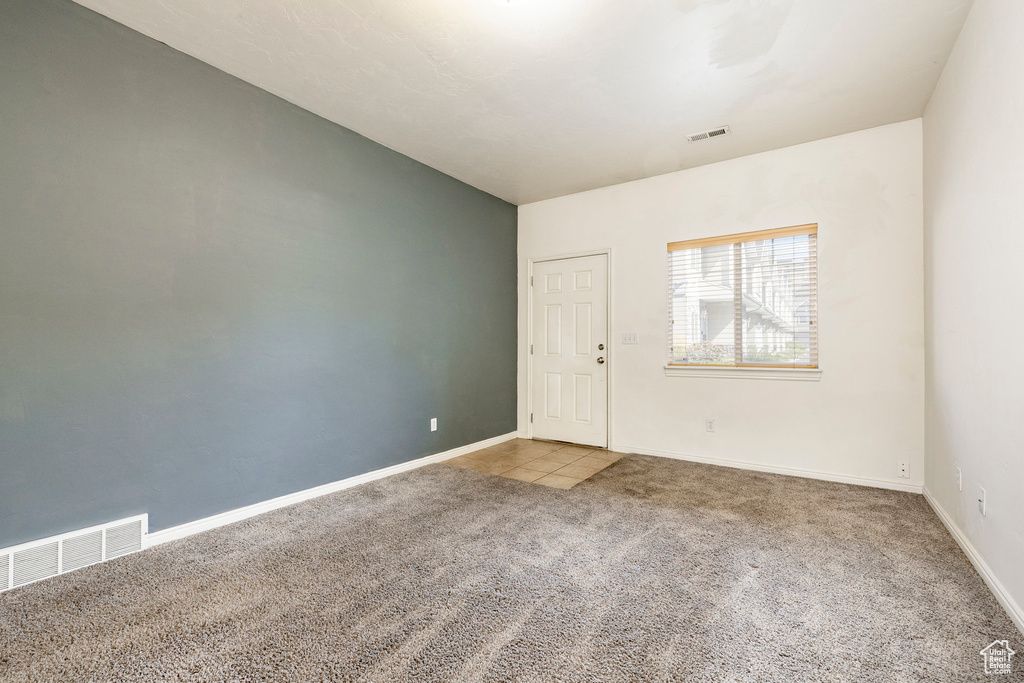 Unfurnished room featuring carpet flooring and baseboards