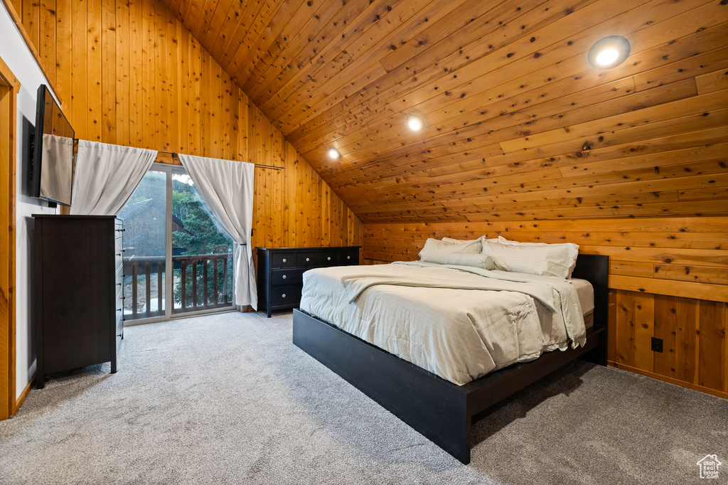 Carpeted bedroom featuring wood walls, wood ceiling, access to exterior, and high vaulted ceiling