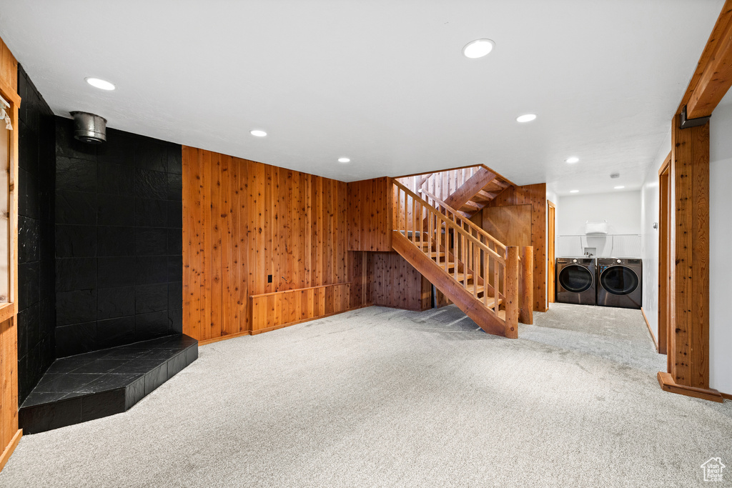 Unfurnished living room featuring recessed lighting, stairway, carpet floors, and washing machine and clothes dryer