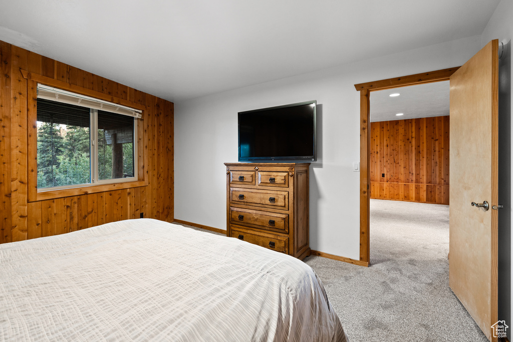 Bedroom featuring wood walls, carpet, and recessed lighting