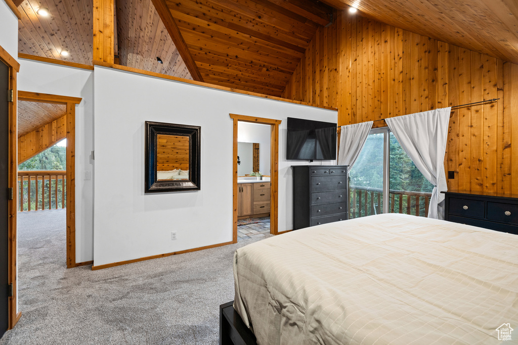 Carpeted bedroom with multiple windows, wood ceiling, access to outside, high vaulted ceiling, and wooden walls