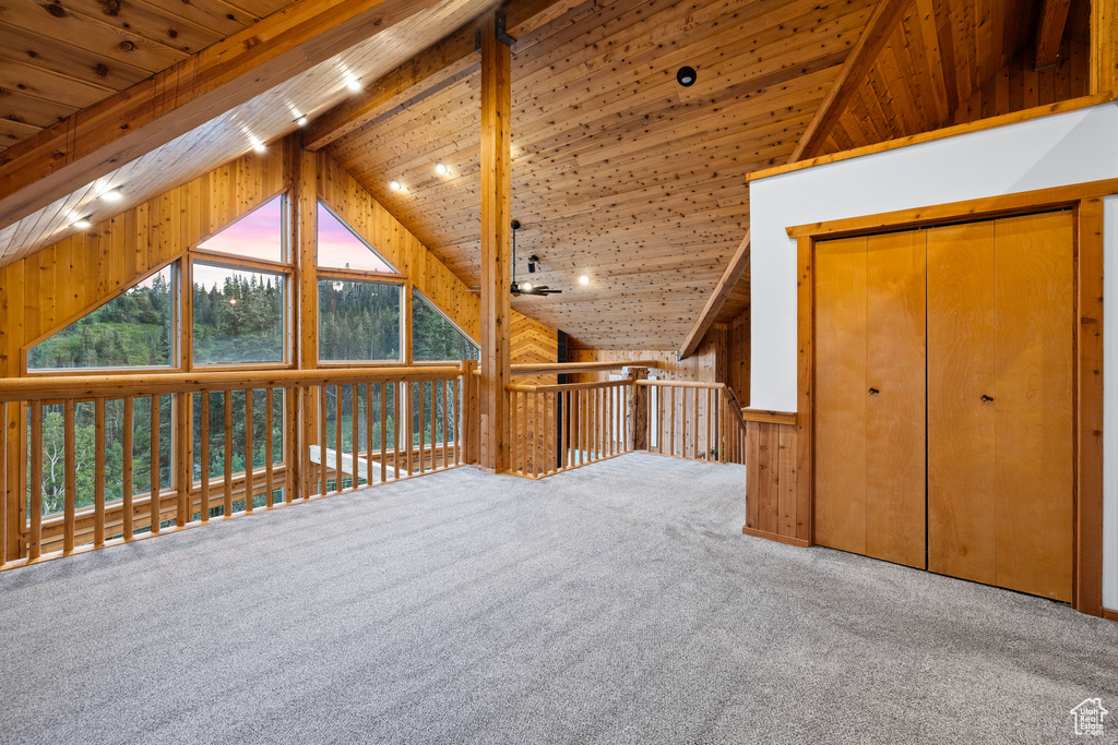 Bonus room with wood ceiling, carpet flooring, and wood walls