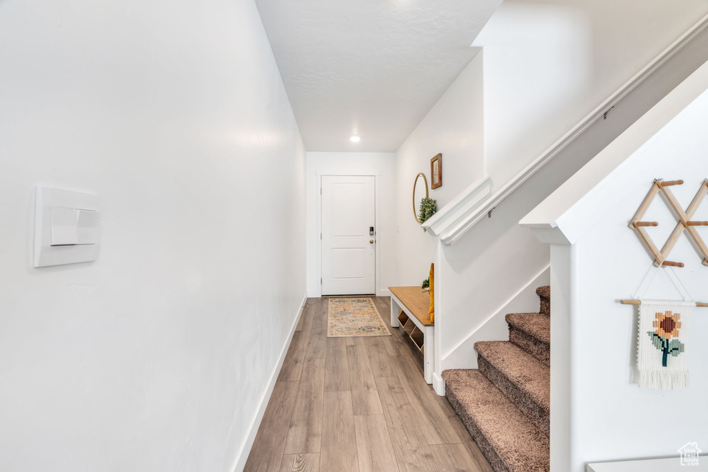 Hall featuring stairway and light wood finished floors