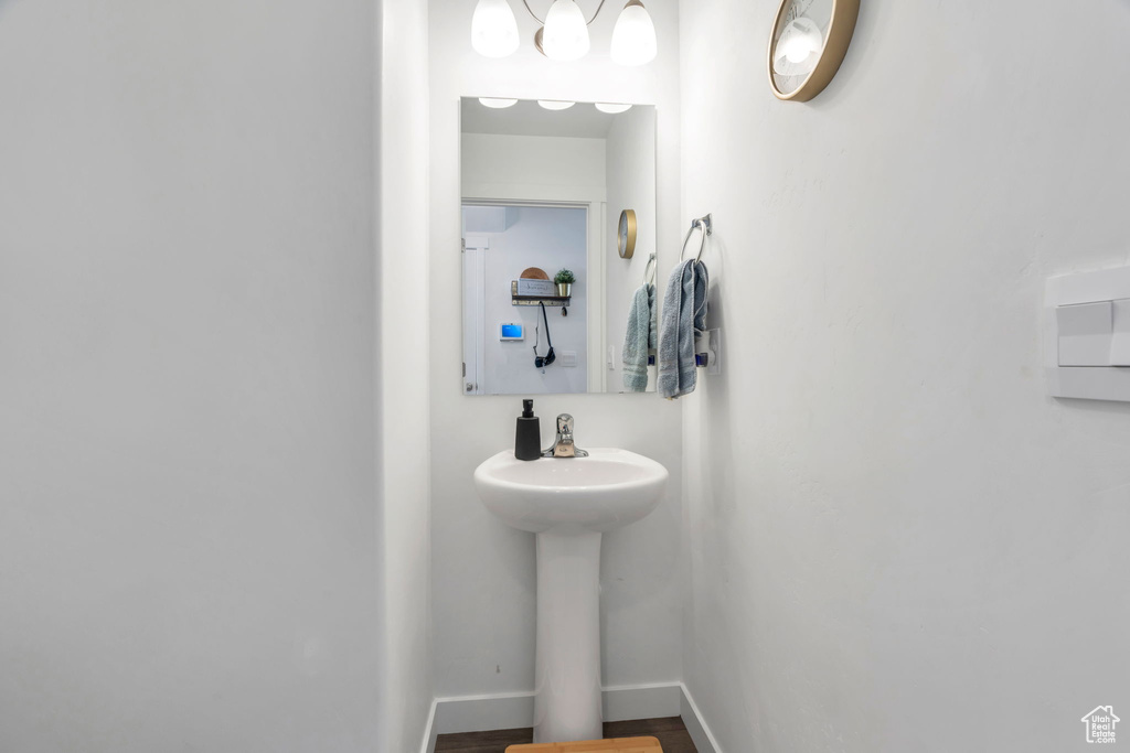 Bathroom with baseboards and wood finished floors